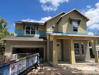 Two-story home under construction features a welcoming front porch and large windows at 3611 Chelsea St, Orlando, FL 32803