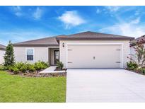 Charming single-Gathering home with manicured lawn, two car garage, and beautiful blue sky at 2674 Sw 165Th Street Rd, Ocala, FL 34473
