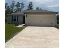 Charming single-story home with a well-maintained lawn and a spacious two-car garage at 2674 Sw 165Th Street Rd, Ocala, FL 34473