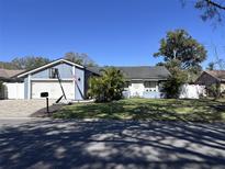 Charming single-Gathering home with a well-maintained front yard and a basketball hoop above the garage at 105 Ingram Cir, Longwood, FL 32779