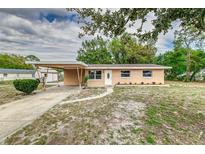 Charming single-story home features a carport and well-maintained front yard at 824 Interlake Dr, Lakeland, FL 33801