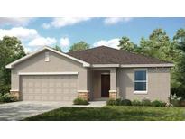 Charming single-story home with a two-car garage and well-maintained landscaping at 7396 Capstone Dr, Groveland, FL 34736