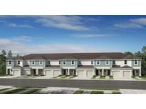 New construction townhomes showcasing a clean and modern architectural design at 2565 Penguin Blvd, Davenport, FL 33837