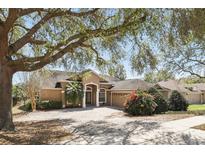 Charming home with a brick driveway, mature trees, and well-manicured landscaping at 1372 Madison Ivy Cir, Apopka, FL 32712