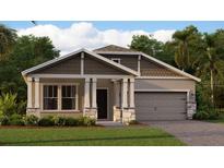 Charming one-story home with a two-car garage, stone accents, and a covered porch at 761 Terrapin Dr, Debary, FL 32713