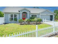 Well-maintained home with a white picket fence, lush lawn, and inviting curb appeal at 3548 Galloway Oaks Ct, Lakeland, FL 33810