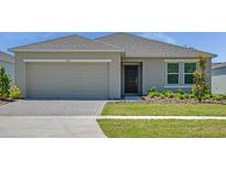 Charming single-story home featuring an attached two-car garage and well-maintained lawn at 140 Jones Fish Camp Rd, Edgewater, FL 32141