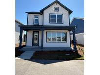 Charming two-story home featuring a welcoming porch and modern architectural details at 3089 Voyager Ave, St Cloud, FL 34771