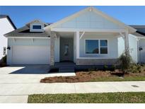 Charming single-story home featuring a light blue exterior, a covered front porch, and an attached two-car garage at 3105 Expedition Dr, St Cloud, FL 34771