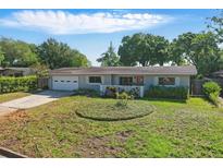 Charming single-story home with a well-manicured lawn and a cozy front porch at 1005 Catalpa Ln, Orlando, FL 32806