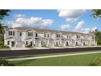 Row of townhomes featuring attached garages, well manicured lawn, and neutral color scheme at 2921 Prosperity Way, Clermont, FL 34714