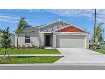 Charming single-story home featuring a two-car garage, well-manicured lawn and simple, clean landscaping at 1026 Foreshore Ln, Haines City, FL 33844