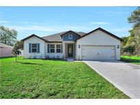 Charming single-story home featuring a well-manicured lawn and welcoming curb appeal at 17745 Sw 25Th Ave Rd, Ocala, FL 34473