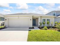 Charming single-story home with a two-car garage, well-maintained lawn, and beautiful landscaping at 2047 Rosewood Cir, Lakeland, FL 33810