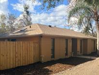 Cozy single-story home featuring a new fence and neutral paint, complemented by well-kept landscaping at 31632 Spruce Dr, Eustis, FL 32736