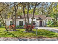 Attractive one-story home with a lush front yard and mature trees in a serene setting at 638 Coral Way, Winter Springs, FL 32708