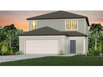 Charming two-story home with a two-car garage, neutral color palette, and well-manicured lawn and landscaping at 1423 Hamilton Way, Lake Alfred, FL 33850