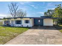 Charming single-story home featuring a covered carport, fresh white paint, and vibrant blue accents at 156 Plumosus Dr, Altamonte Springs, FL 32701