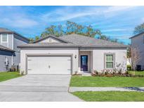Charming single-Gathering home featuring a two-car garage, well-manicured lawn, and covered front entry at 13276 Tula Loop, Astatula, FL 34705