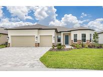 Charming single-story home with a manicured lawn, a two-car garage, and a welcoming entrance at 8734 Sw 55Th Street Rd, Ocala, FL 34481