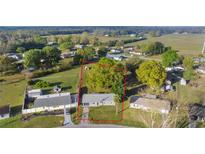Aerial view of a charming single Gathering home with a mature lawn and property boundaries at 5728 Ne 21St Avenue Rd, Ocala, FL 34479