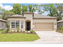 Charming single-story home with a manicured lawn, brick driveway, and a two-car garage at 8787 Sw 52Nd Place Rd, Ocala, FL 34481
