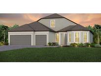 Charming two-story home with a three-car garage and a well-maintained front yard at 8980 Sw 52Nd Place Rd, Ocala, FL 34481