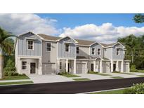 Charming townhome featuring a private garage and beautifully landscaped front yard at 2628 Armstrong Ave, Clermont, FL 34714