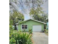 Charming single-story home with a well-maintained lawn and driveway leading to an attached garage at 1527 E Elm Rd, Lakeland, FL 33801