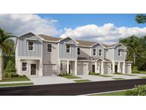 Charming new construction townhomes featuring a modern facade and attached garages at 2910 Savior Ave, Davenport, FL 33837