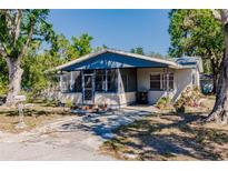 Charming single-story home featuring a screened-in porch and mature trees in a serene neighborhood at 4290 Trainer Rd, Bartow, FL 33830