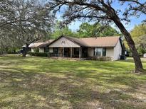 Charming single-story home featuring a covered front porch and a well-maintained front lawn at 4586 Cr 696, Webster, FL 33597