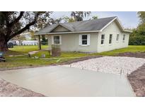 Charming single-story home with a new driveway and well-maintained lawn at 203 Glenwood Dr, Lakeland, FL 33805