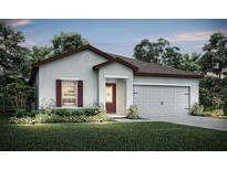 Charming single-story home with a well-manicured lawn, attached two-car garage and inviting front entrance at 1633 Nantucket Way, Winter Haven, FL 33884