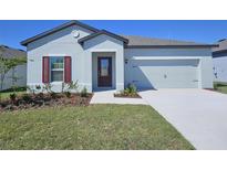 Charming single-story home with a two-car garage and beautifully landscaped front yard at 1645 Nantucket Way, Winter Haven, FL 33884