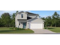 Charming two-story home with a well-manicured lawn, attached two-car garage, and stylish blue front door at 951 Hour Glass Rd, Lakeland, FL 33801