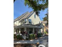 Charming two-story townhome featuring a welcoming covered front porch and landscaped surroundings at 3324 Parkchester Square Blvd # 102, Orlando, FL 32835