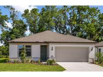 Charming single-story home featuring a two-car garage, well-maintained lawn and lush landscaping at 8249 Sw 52Nd Lane Rd, Ocala, FL 34481