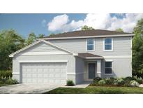 Charming two-story home with a two-car garage, landscaped yard, and light grey siding at 2418 Slippery Rock St, Auburndale, FL 33823