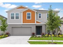 Charming two-story home featuring a landscaped yard, integral garage, and welcoming entrance at 1616 Ellesmere Ave, Haines City, FL 33844