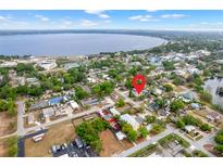 Scenic aerial view of the property with a lake view and nearby neighborhood at 883 10Th St, Clermont, FL 34711
