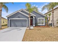 Charming single-Gathering home with a well-maintained lawn and an attached two-car garage at 438 Cotswold Cir, Davenport, FL 33837