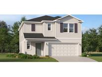 Charming two-story home featuring neutral siding, a two-car garage and well manicured landscaping at 3443 Howell Dr, Lake Wales, FL 33859