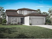 Charming two-story home with a two-car garage and well-manicured lawn at 13272 Tula Loop, Astatula, FL 34705
