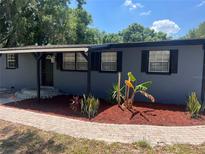 Charming home featuring dark shutters and colorful landscaping, enhancing curb appeal at 5580 Hwy 542 W, Winter Haven, FL 33880