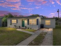 Charming home featuring a green front door, well-maintained lawn, and a driveway, captured at dusk at 2625 Williston Dr, Lakeland, FL 33801