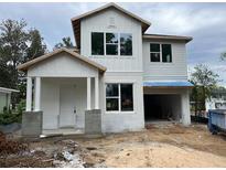 New construction two-story home featuring a two-car garage and bright white siding at 1205 Eastin Ave, Orlando, FL 32804