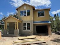 New home exterior with large windows and an attached garage is under construction on a sunny day at 1205 Eastin Ave, Orlando, FL 32804