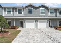 Charming townhome featuring a gray exterior, attached garage, and well-maintained landscaping at 350 N 1St Ave, Bartow, FL 33830