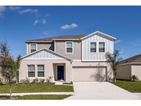 Charming two-story home featuring a two-car garage, a well-manicured lawn, and beautiful curb appeal at 1030 Foreshore Ln, Haines City, FL 33844